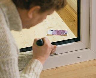 Fenstersicherung von Hanse Haus Mann beim Prüfen der Fenstersicherung der Hanse Haus Fenster